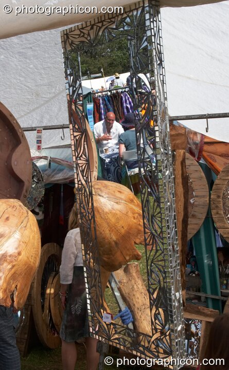 Reflections in a mirror on a stall at Big Green Gathering 2007. Burrington, Cheddar, United Kingdom. © 2007 Photographicon