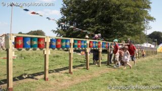A group of youths turn the Tibetan Buddhist prayer wheels in the Healing Field at Big Green Gathering 2007. Burrington, Cheddar, United Kingdom. © 2007 Photographicon