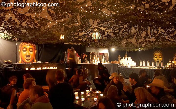 Festival goers enjoy refreshments by the night eye of the Budha in Chai Wallah at Glade Festival 2005. Aldermaston, United Kingdom. © 2005 Photographicon