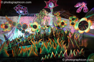 Colourful decorative model plants in the night time Ultra Violet garden at Glade Festival 2005. Aldermaston, United Kingdom. © 2005 Photographicon