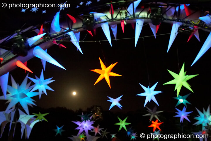 The moon framed by the Tribe of Frogs decor on the Origin Stage at Glade Festival 2006. Aldermaston, United Kingdom. © 2006 Photographicon