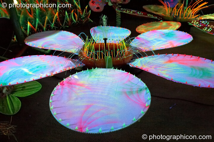 Brightly coloured model flowers in the Ultra Violet garden (part of the Soma chillout area) at Glade Festival 2006. Aldermaston, United Kingdom. © 2006 Photographicon