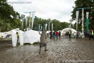 People walking in the mud around the IDspiral arena at Glade Festival 2007. Aldermaston, United Kingdom. © 2007 Photographicon