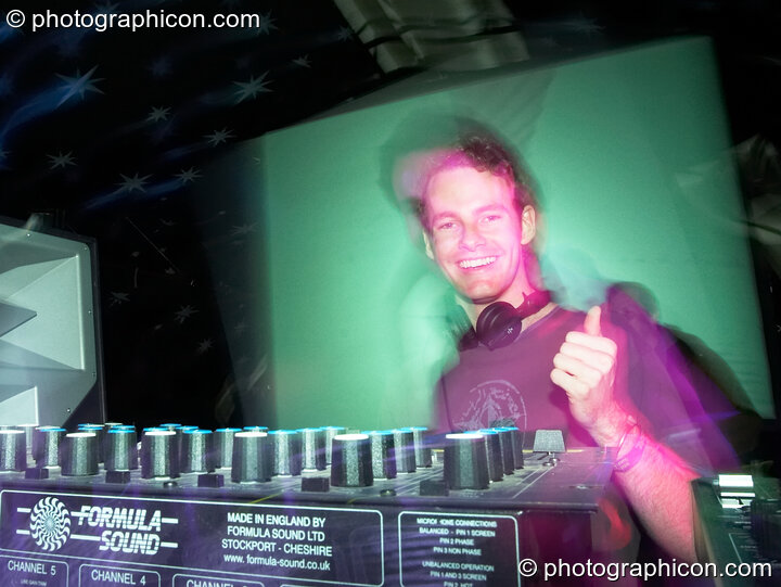 Headroom (Adam Metcalfe - Nano Records) gives a thumbs up to his seemingly large mixer while performing on the Origin Stage at Glade Festival 2007. Aldermaston, United Kingdom. © 2007 Photographicon