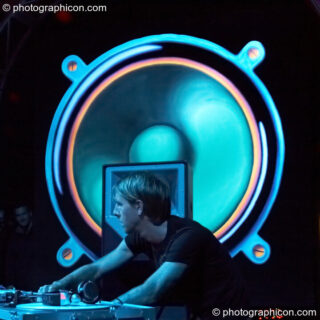 Richie Hawtin performs with his head profiled by a giant painted speaker backdrop on the Vapor Stage at Glade Festival 2007. Aldermaston, United Kingdom. © 2007 Photographicon