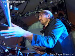 Henrik Vibskov of Trentemoller (Poker Flat Recordings) in close side profile as his stick reaches for the drums on the Glade Stage at Glade Festival 2007. Aldermaston, United Kingdom. © 2007 Photographicon