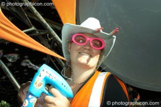 A wonkily dressed Oxfam steward uses her bubble gun outside the Origin Stage at Glade Festival 2007. Aldermaston, United Kingdom. © 2007 Photographicon