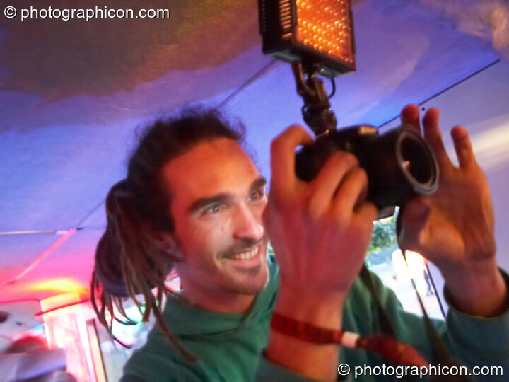 A smiling photographer  in the Boom Bus at Glade Festival 2011. King's Lynn, United Kingdom. © 2011 Photographicon