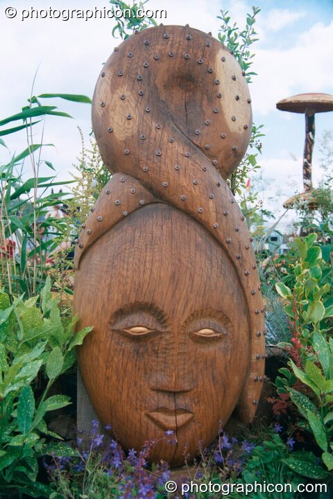 A wooden carving of a woman's head at Glastonbury Festival 2002. Pilton, United Kingdom. © 2002 Photographicon