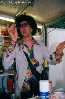 A man selling coffee in the Lost Vaguess field at Glastonbury Festival 2002. Pilton, United Kingdom. © 2002 Photographicon