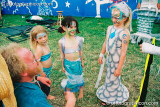 Girls in mermaid costume at Glastonbury Festival 2003. Pilton, United Kingdom. © 2003 Photographicon