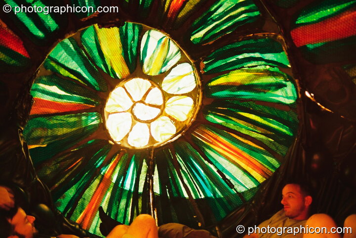 Inside a large snail shell seating chamber at Glastonbury Festival 2003. Pilton, United Kingdom. © 2003 Photographicon