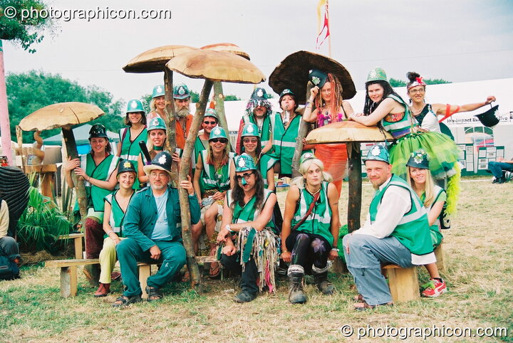 Group photo of the Green Police amongst the mushrooms at Glastonbury Festival 2003. Pilton, United Kingdom. © 2003 Photographicon