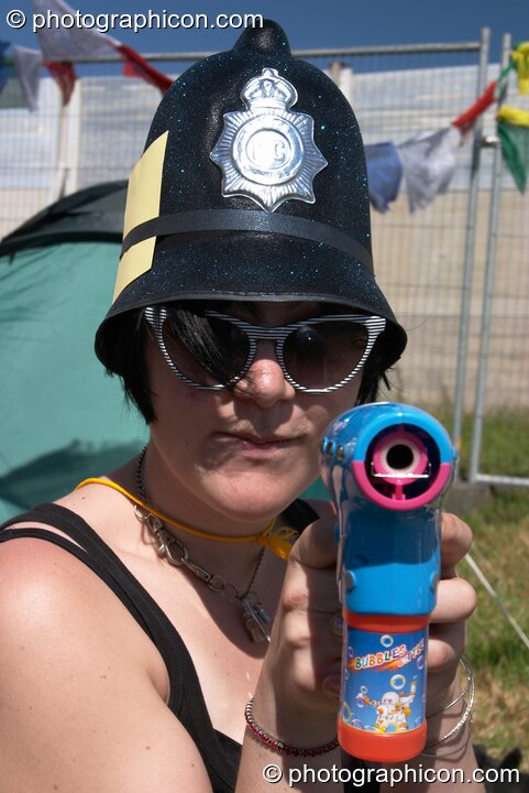 Armed woman Green Police officer at Glastonbury Festival 2004. Pilton, United Kingdom. © 2004 Photographicon