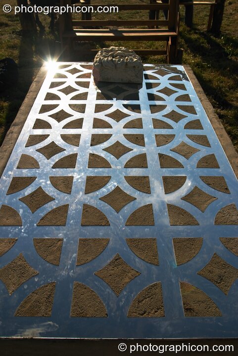 A large slab of stone inlaid with glass mirror at Glastonbury Festival 2004. Pilton, United Kingdom. © 2004 Photographicon