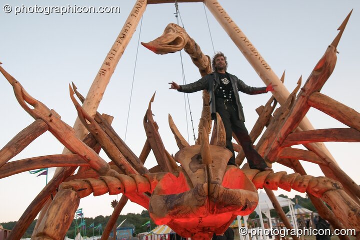 A member of the Tree Pirates on top of their 25 foot Scorpion chainsaw sculpture at Glastonbury Festival 2004. Pilton, United Kingdom. © 2004 Photographicon