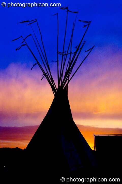 An tipi against a colour-manipulated dawn sky at Glastonbury Festival 2004. Pilton, United Kingdom. © 2004 Photographicon