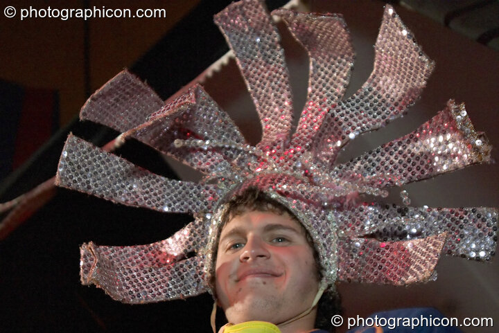 A man wearing a mirror hat in the Lost Vagueness Casino at Glastonbury Festival 2004. Pilton, United Kingdom. © 2004 Photographicon