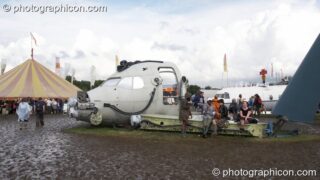 An aircraft cockpit makes for a good performance stage in Trash City at Glastonbury Festival 2007. Pilton, United Kingdom. © 2007 Photographicon