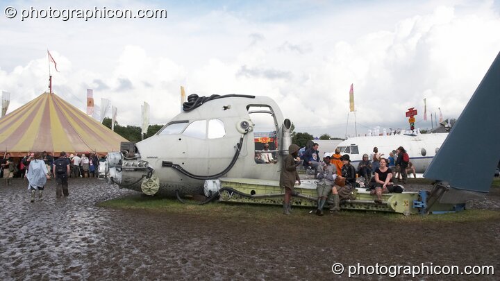 An aircraft cockpit makes for a good performance stage in Trash City at Glastonbury Festival 2007. Pilton, United Kingdom. © 2007 Photographicon