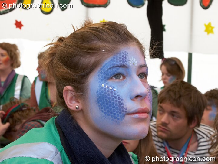 Portrait of a Green Police officer as they prepare their costume, with face painting by Simone Kay & her team, at Glastonbury Festival 2008. Pilton, United Kingdom. © 2008 Photographicon