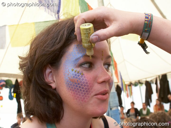 Portrait of a Green Police officer as they prepare their costume, with face painting by Simone Kay & her team, at Glastonbury Festival 2008. Pilton, United Kingdom. © 2008 Photographicon