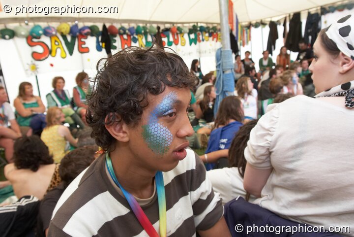 Portrait of a Green Police officer as they prepare their costume, with face painting by Simone Kay & her team, at Glastonbury Festival 2008. Pilton, United Kingdom. © 2008 Photographicon