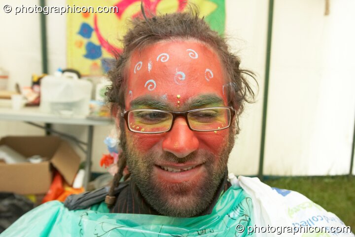 Portrait of a Green Police officer as they prepare their costume, with face painting by Simone Kay & her team, at Glastonbury Festival 2008. Pilton, United Kingdom. © 2008 Photographicon