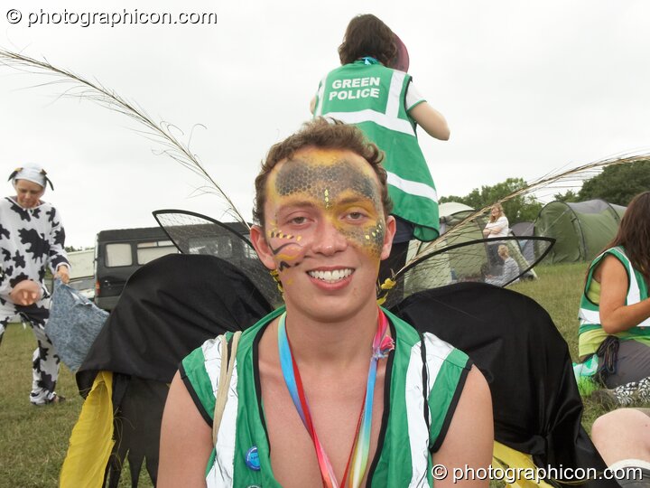 Portrait of a Green Police officer as they prepare their costume, with face painting by Simone Kay & her team, at Glastonbury Festival 2008. Pilton, United Kingdom. © 2008 Photographicon