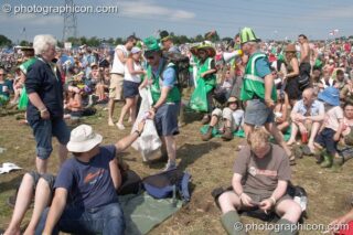 Green Police in action encouraging the public to pick up litter in the main arena at Glastonbury Festival 2005. Pilton, United Kingdom. © 2005 Photographicon