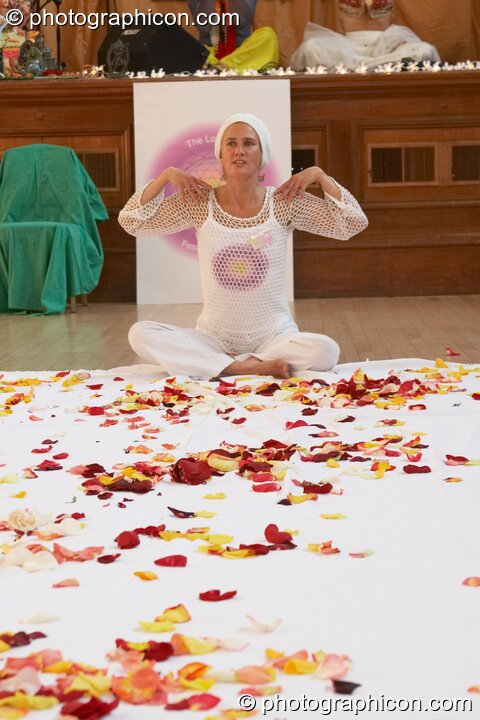 Kate McKenzie sits on a rose petal covered sheet at the London Festival of Tantra 2008. London, United Kingdom. © 2008 Photographicon