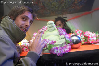 Stu venerates a plastic decorated Buddha on the Main Stage at Planet Bob's Offworld Festival 2007. Swindon, United Kingdom. © 2007 Photographicon