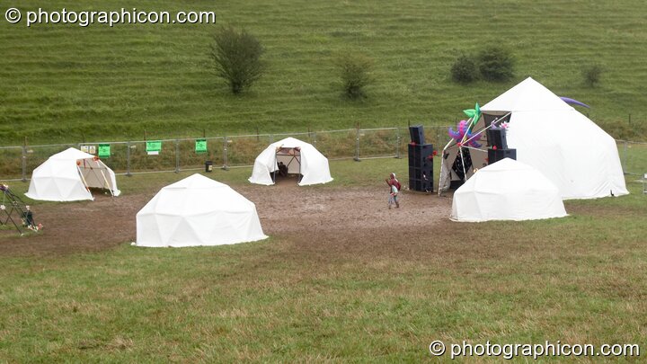 A woman dances on her own in the rain and mud outside the Main Stage at Planet Bob's Offworld Festival 2007. Swindon, United Kingdom. © 2007 Photographicon