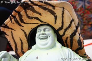 A plastic Buddha decorated with fluro flowers and hat on the Main Stage at Planet Bob's Offworld Festival 2007. Swindon, United Kingdom. © 2007 Photographicon
