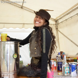 A lady serves behind the Nectar Cafe at the Secret Garden Party 2006. Huntingdon, United Kingdom. © 2006 Photographicon