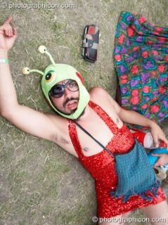 A man in fancy dress finds the floor comforting at the Secret Garden Party 2007. Huntingdon, United Kingdom. © 2007 Photographicon