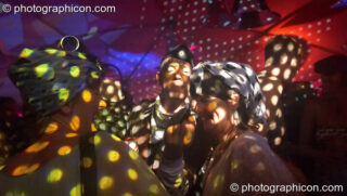 Dots of coloured light swirl across the dancers in the Fish Seeks Bicycle's Looniverse tent at the Secret Garden Party 2007. Huntingdon, United Kingdom. © 2007 Photographicon