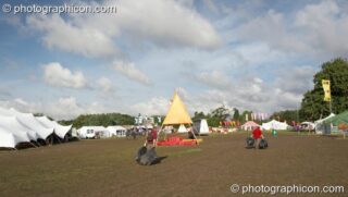 Litter pickers drag their catch away at the Secret Garden Party 2007. Huntingdon, United Kingdom. © 2007 Photographicon