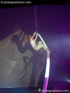 Claire O'Neill performs aerial silk acrobatics in the Remix Tent at the Secret Garden Party 2010. Huntingdon, United Kingdom. © 2010 Photographicon