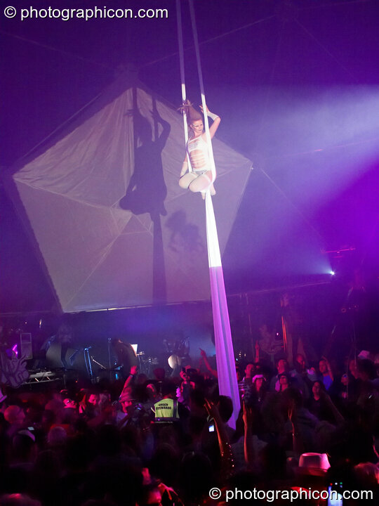 Claire O'Neill performs aerial silk acrobatics in the Remix Tent at the Secret Garden Party 2010. Huntingdon, United Kingdom. © 2010 Photographicon