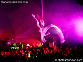 Claire O'Neill performs aerial silk acrobatics in the Remix Tent at the Secret Garden Party 2010. Huntingdon, United Kingdom. © 2010 Photographicon