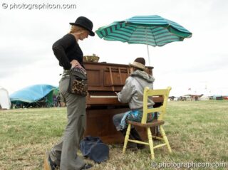 Punters play piano in a field at Sunrise Celebration 2006. Yeovil, United Kingdom. © 2006 Photographicon