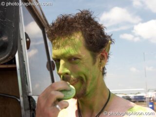 Glen applies his green pixie costime as part of the Eco Rangers team at Sunrise Celebration 2007. Yeovil, United Kingdom. © 2007 Photographicon