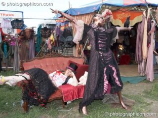 A woman sleeps on a couch next to a dress mannequin outside the Prangsta costumiers stall at Sunrise Celebration 2007. Yeovil, United Kingdom. © 2007 Photographicon