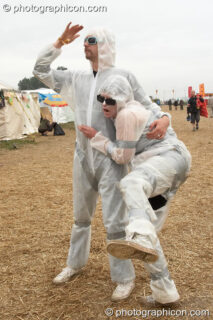 A man and woman dressed in plastic pose for the camera at Sunrise Celebration 2007. Yeovil, United Kingdom. © 2007 Photographicon