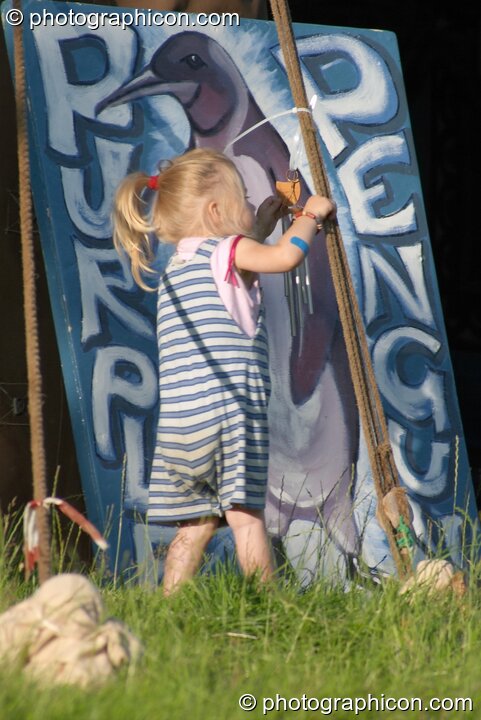 A little girl plays outside the Purple Penguin Cafe Turaya Gathering 2004. Wimborne, United Kingdom. © 2004 Photographicon