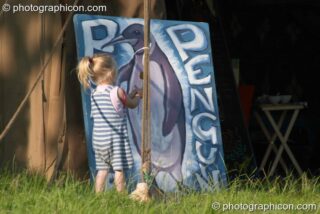 A little girl plays outside the Purple Penguin Cafe Turaya Gathering 2004. Wimborne, United Kingdom. © 2004 Photographicon