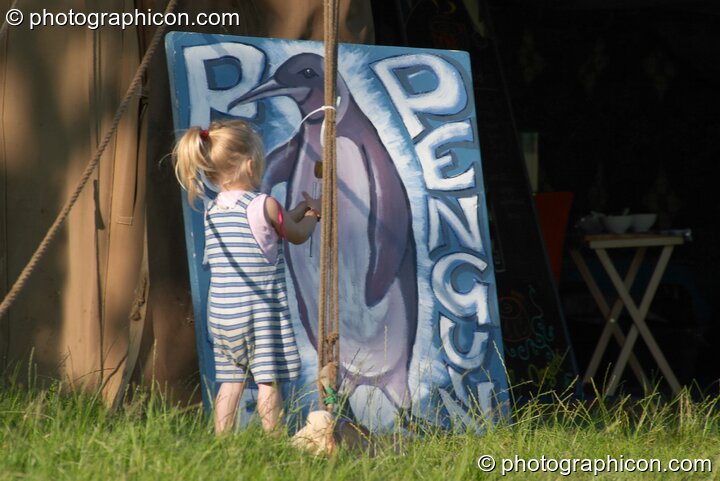A little girl plays outside the Purple Penguin Cafe Turaya Gathering 2004. Wimborne, United Kingdom. © 2004 Photographicon