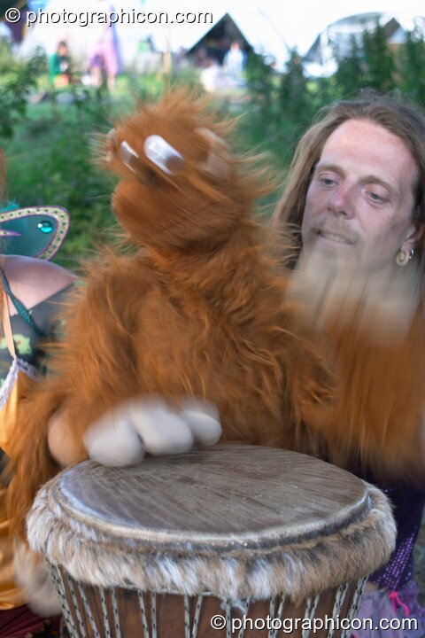 A man plays a drum with a hand puppet at the Turaya Gathering 2004. Wimborne, United Kingdom. © 2004 Photographicon