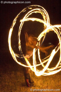 Fire sticks photographed at slow shutter speed to produce motion trails at the Turaya Gathering 2004. Wimborne, United Kingdom. © 2004 Photographicon